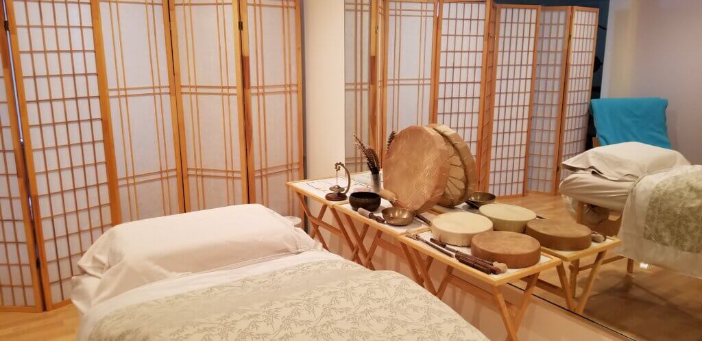 Claire's Reiki Office with a reiki table, drums, and Tibetan singing bowls